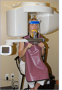 A woman undergoing CT scan of her jaw before treatment at Periodontal Surgical Arts in Austin, TX