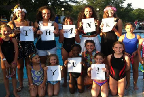 Travis Country Swim Club 2013 holding thank you letters in big cards.