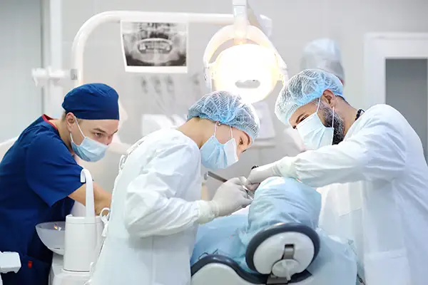 A team of dentists and oral surgeons performing teeth in a day implant procedure on a patient at Periodontal Surgical Arts in Austin, TX
